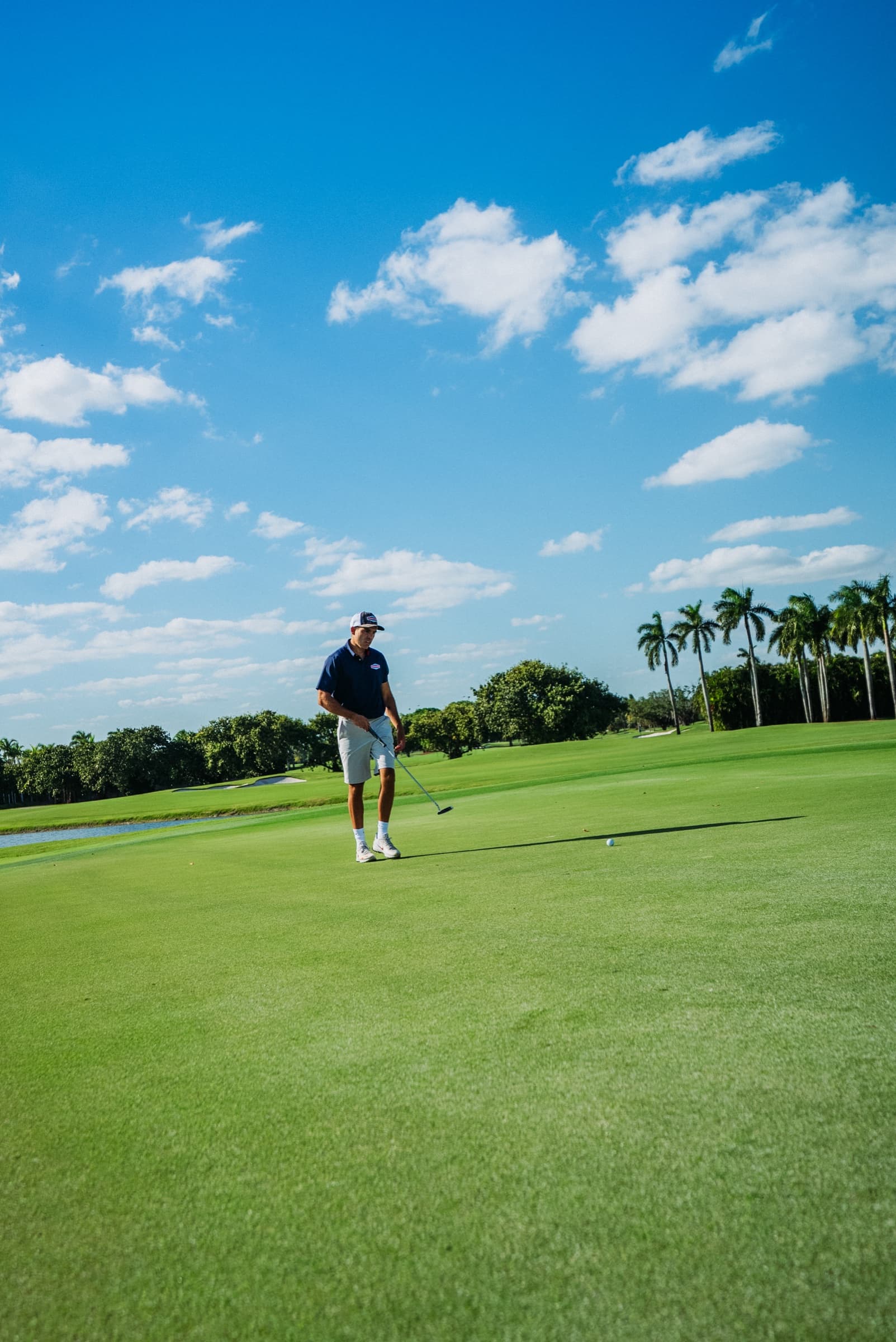 Small figure of a golfer on a vast fairway