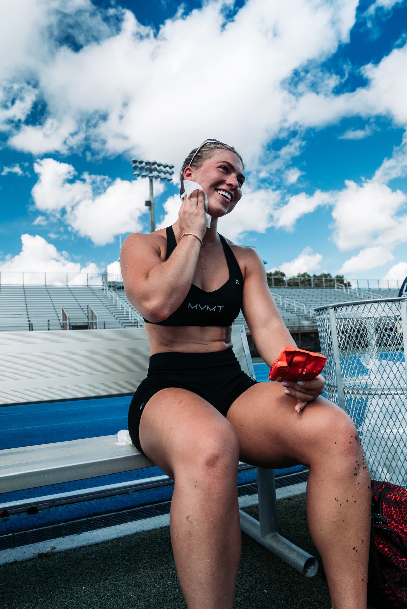 Athlete laughing on a stadium bench